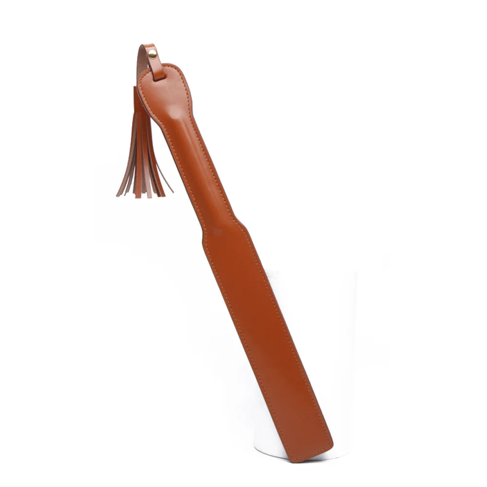 Brown leather paddle with tassel on white background