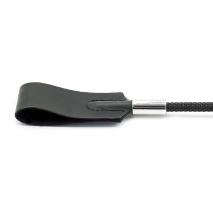 Close-up of square faux leather tip on classic riding crop