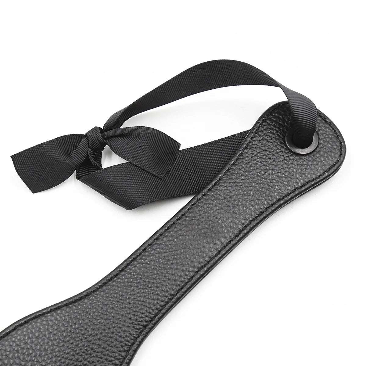 Ribbon-style wrist strap detail on black discipline paddle