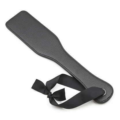Slim black spanking paddle on white background