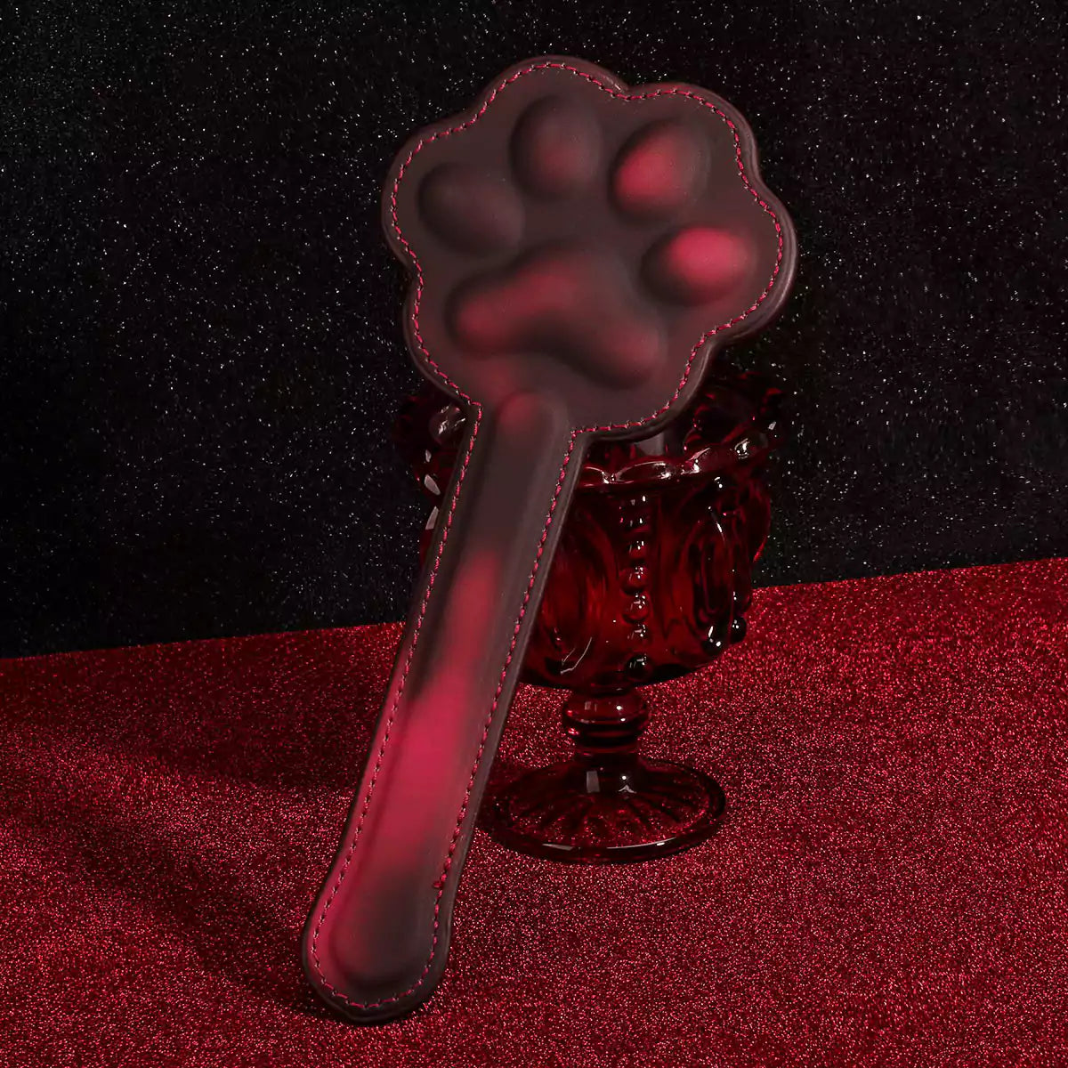 Cat paw heat-reactive spanking board in playful scene setting