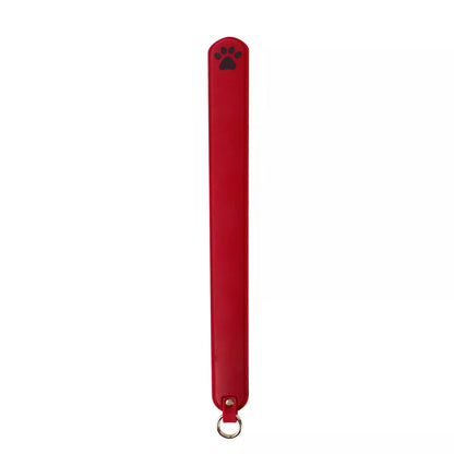 Red silicone cat paw paddle on white background