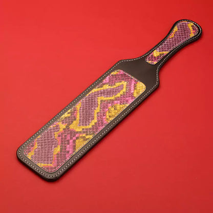 Python textured leather spanking paddle front view on red background