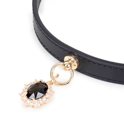 Close-up detail of crystal-style gem pendant on leather collar