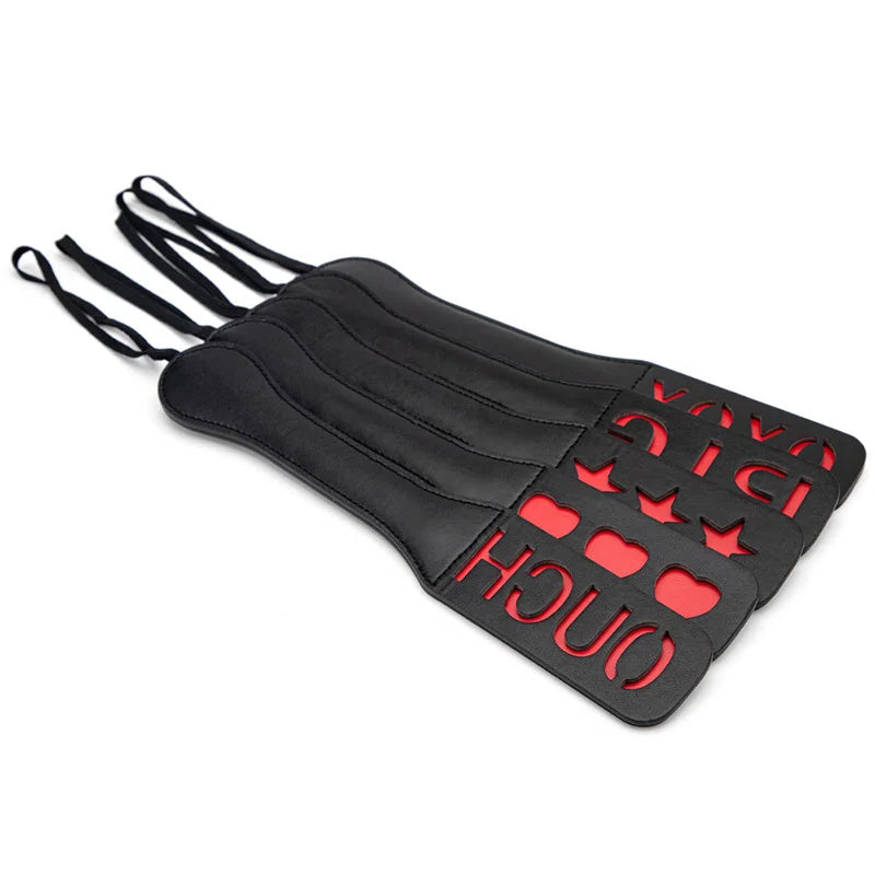 multiple decorative cutout BDSM paddles displayed together
