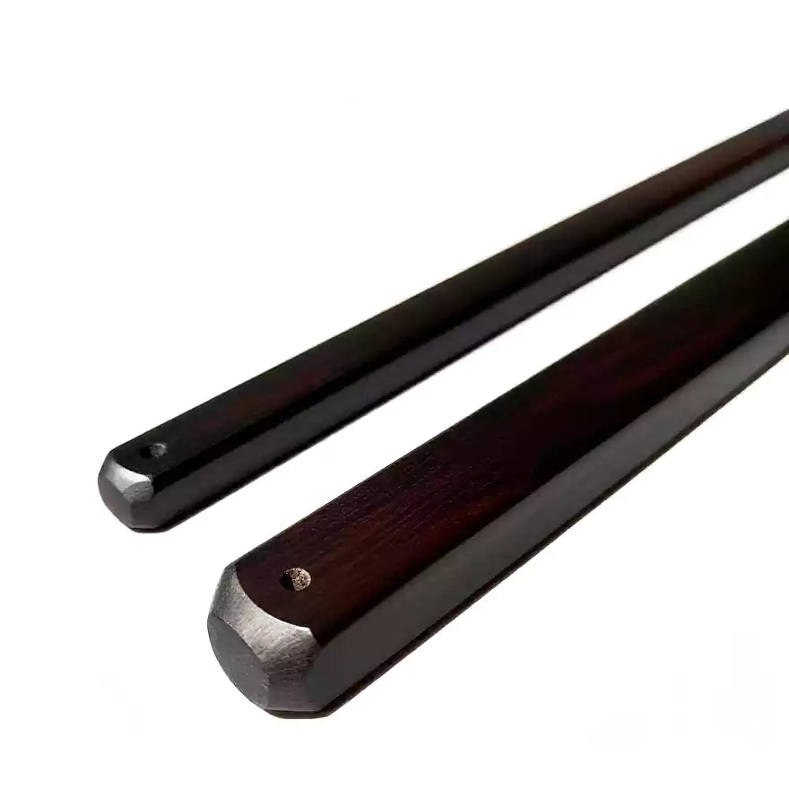 Close-up of ebony square discipline rod showing edge profile and wood grain