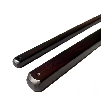 Close-up of ebony square discipline rod showing edge profile and wood grain