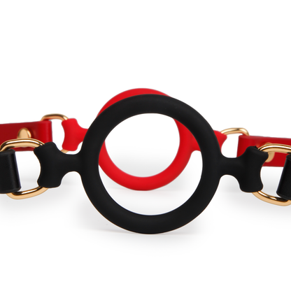 Close-up comparison of black and red Eye of Horus ring gags showing their silicone ring details