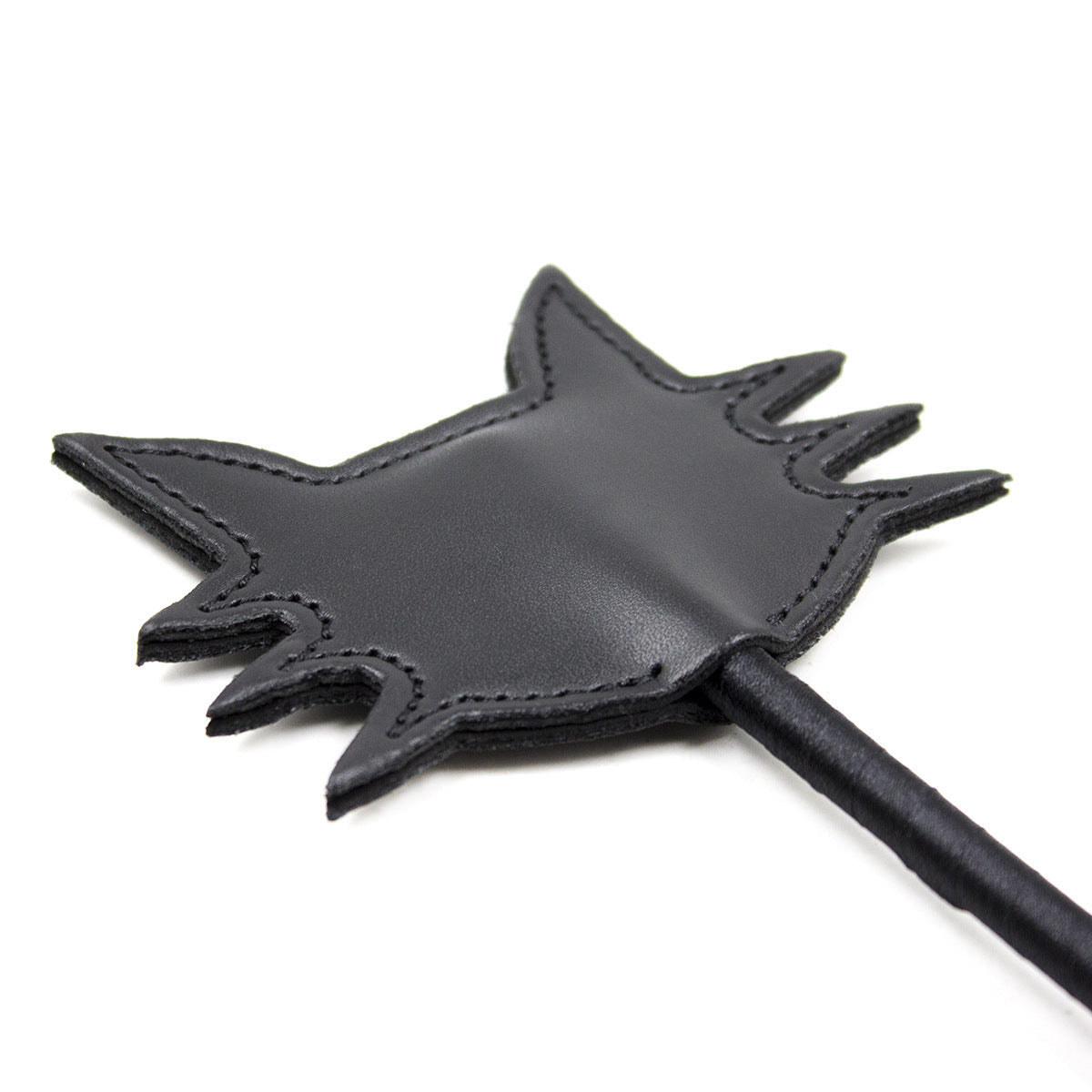Angled close-up of the black cat face paddle head on the feline silhouette riding crop