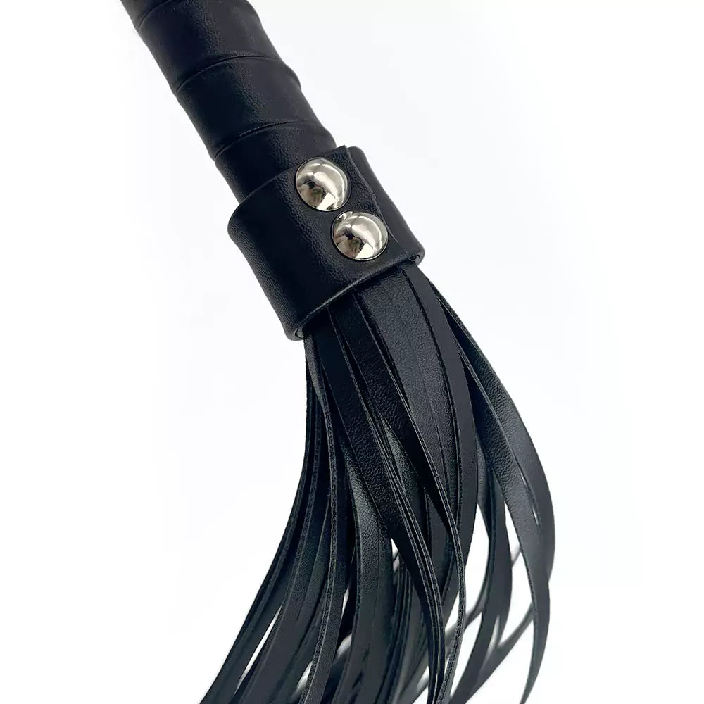 Detail of multistrand flogger falls connected to black handle