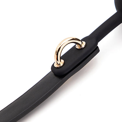 Latex ball and strap connection detail with gold-tone ring