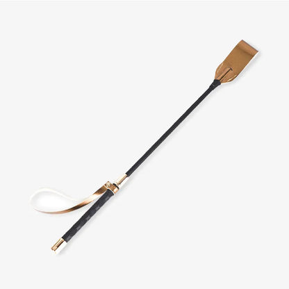 Gold metallic riding crop full view showing shiny finish and hanging loop
