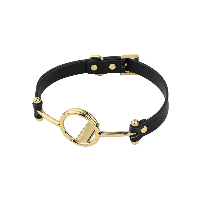 angled full view showing rigid gold O-ring and integrated tongue press for structured dominance display