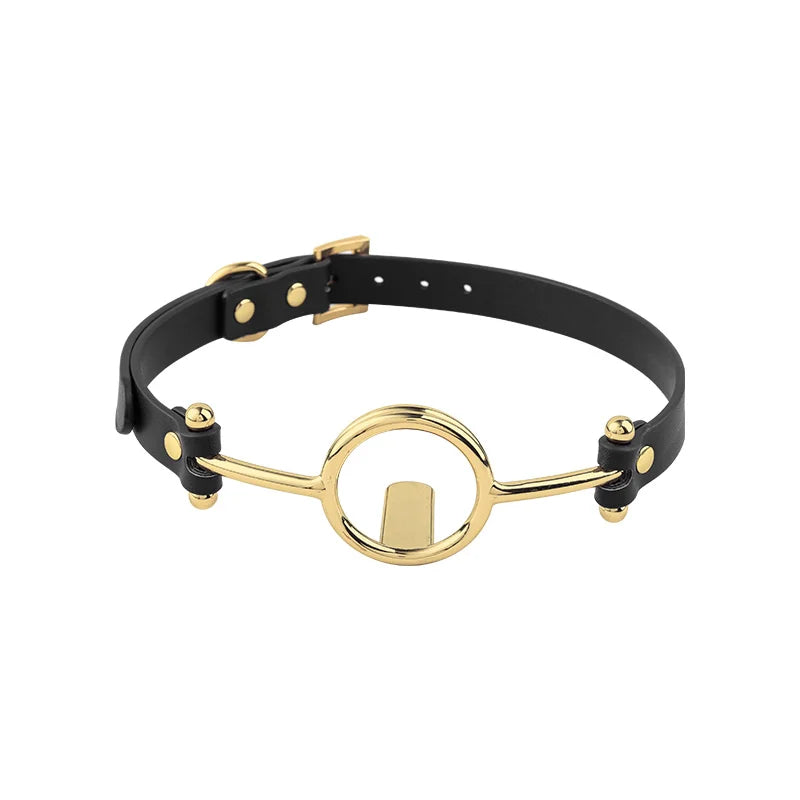 full view of gold-ring tongue depressor gag with black faux leather straps for open-mouth exposure
