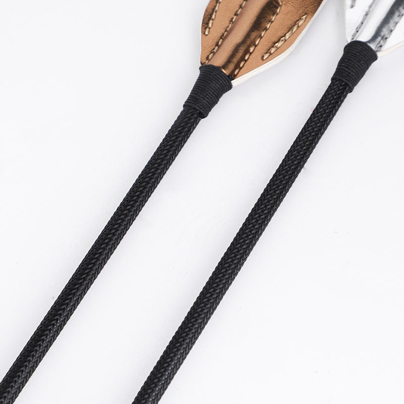 Close comparison of gold and silver metallic finish on BDSM riding crops