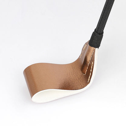 Close-up of metallic paddle head showing gold and silver finish