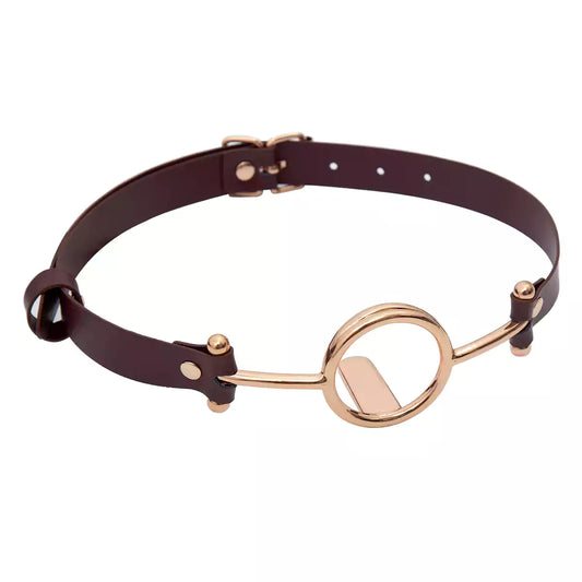 front view of gold plated tongue depressor ball gag with brown strap and polished hardware