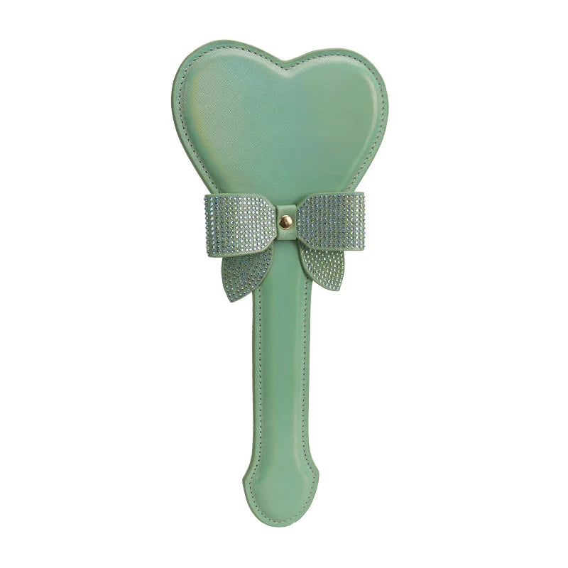 Green iridescent heart-shaped spanking paddle full view with shiny faux leather finish