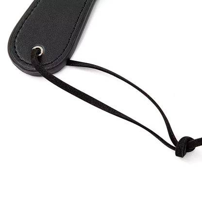 Detail of wrist loop on plush heart paddle
