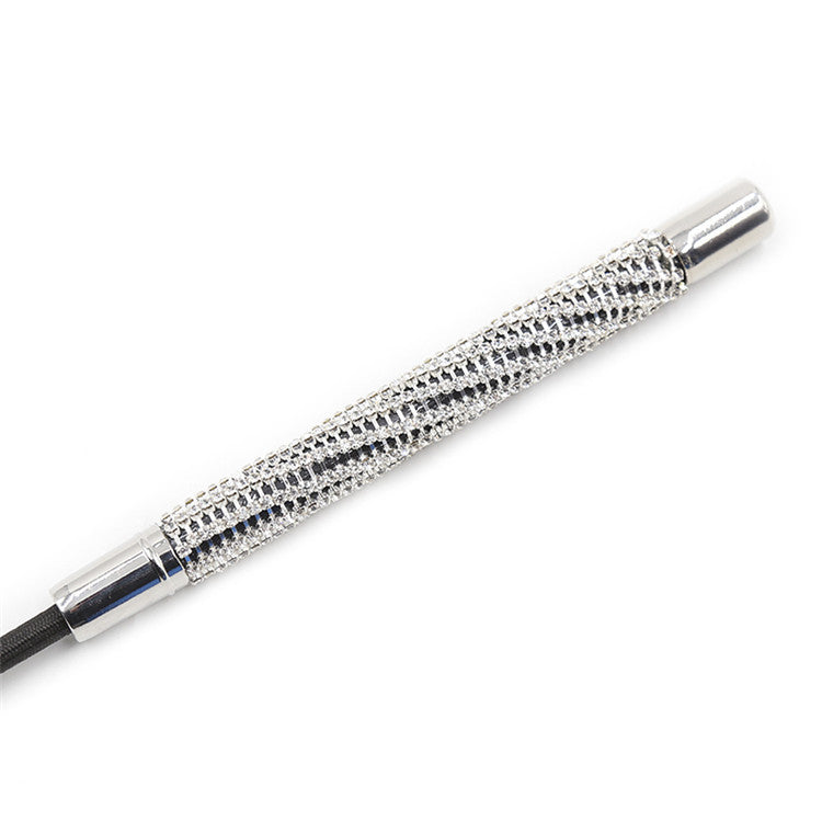 Close-up of rhinestone diamond-studded handle on heart tip riding crop