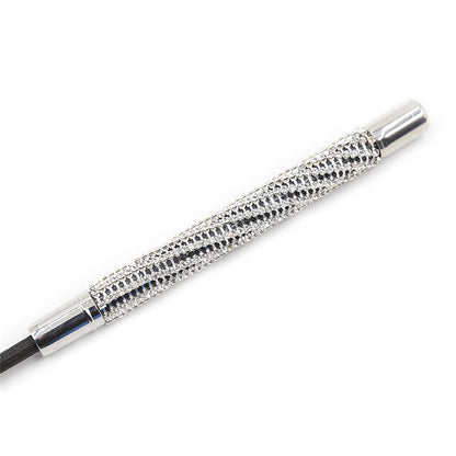 Close-up of rhinestone diamond-studded handle on heart tip riding crop