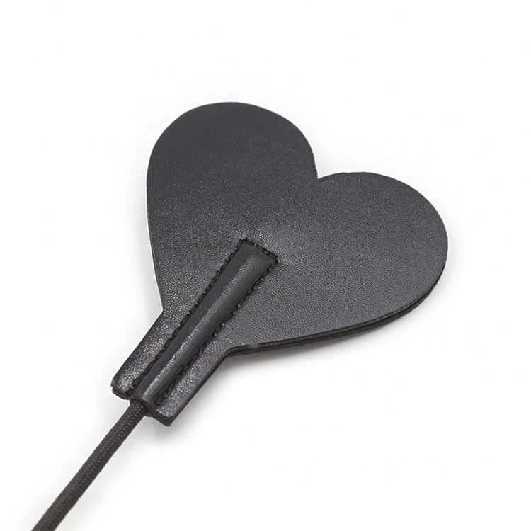 Back surface close-up of heart-shaped tip on diamond handle riding crop
