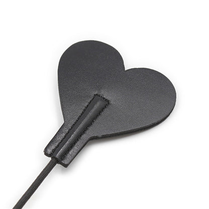 Back surface close-up of heart-shaped tip on diamond handle riding crop