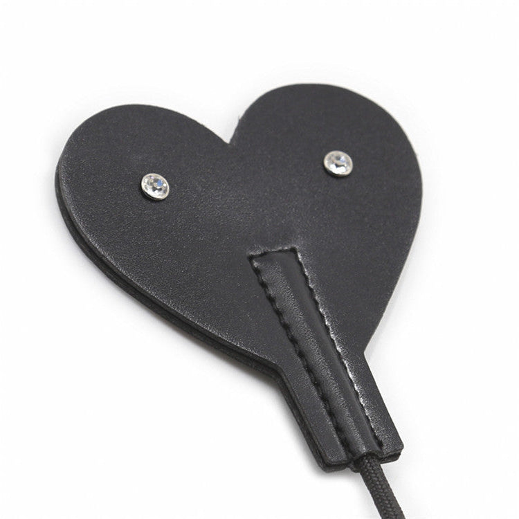 Close-up front view of heart-shaped faux leather tip on diamond handle crop