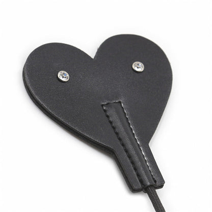 Close-up front view of heart-shaped faux leather tip on diamond handle crop