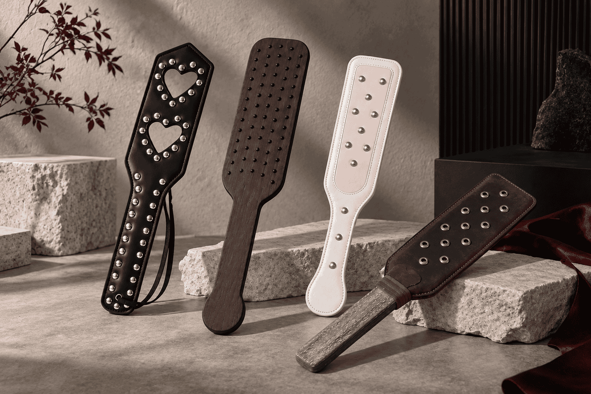 Studded spanking paddles with different stud patterns, surface coverage and designs