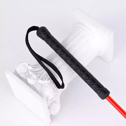 Close-up of rubber anti-slip handle on lace flower riding crop