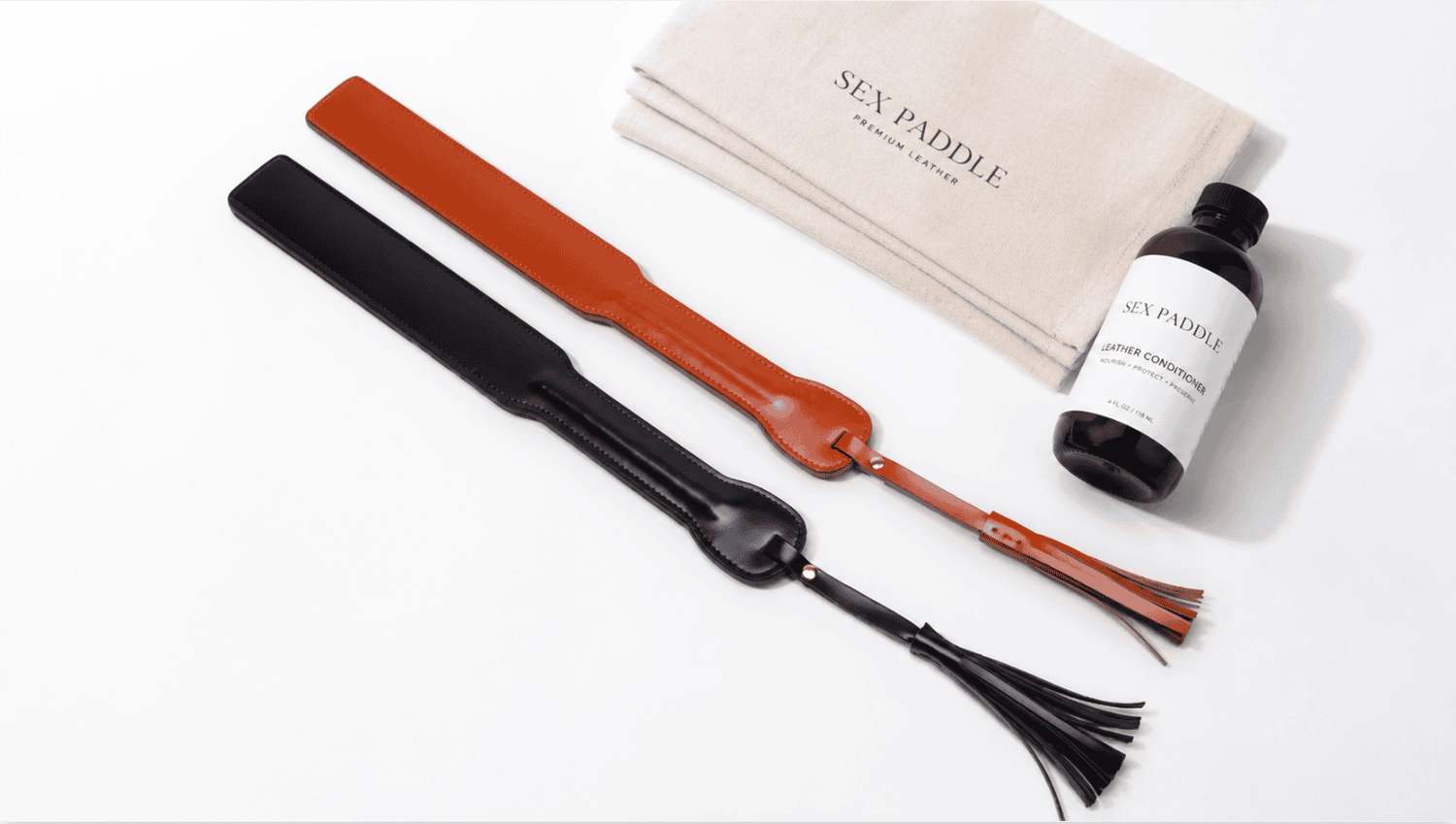 Leather spanking paddle care setup with surface cleaning and dry storage.