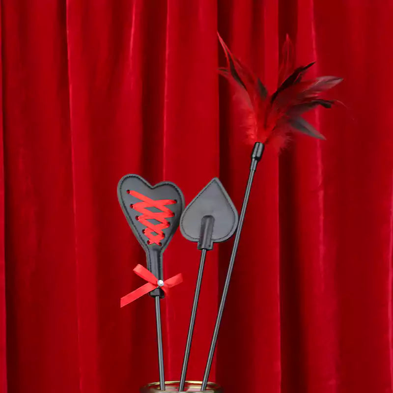 Long-handle riding crop on red background showing all three styles