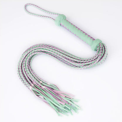 front view of mint and purple nine-tail leather flogger showing flowing braided strands