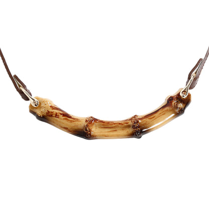 Close-up detail of the natural bamboo ball gag and polished bamboo bar mouthpiece