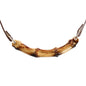 Close-up detail of the natural bamboo ball gag and polished bamboo bar mouthpiece
