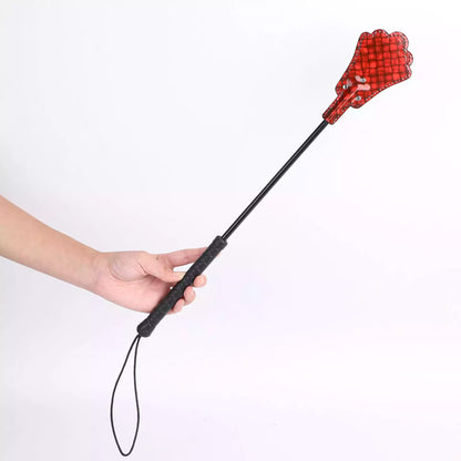 Neon plaid riding crop held in hand showing rubber grip and length