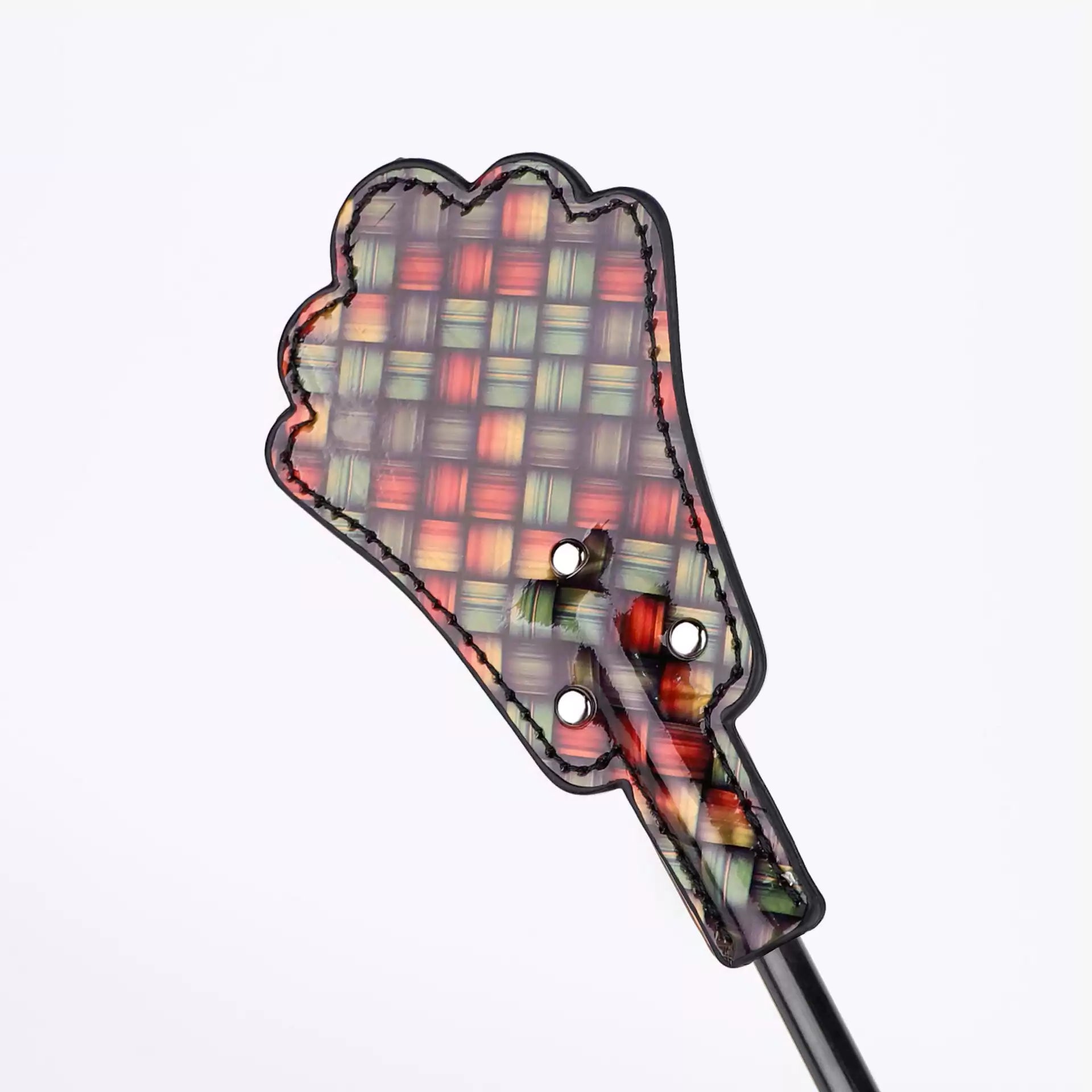 Close-up of metal stud accents on neon plaid fan-shaped crop head