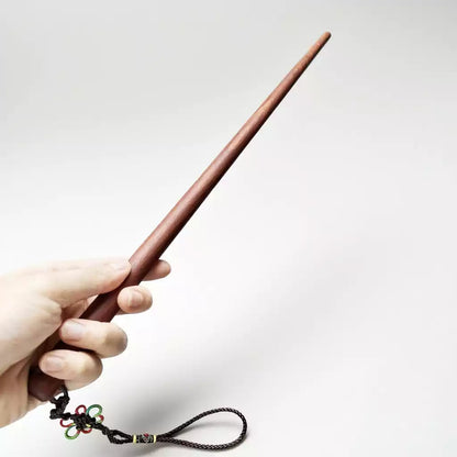 Padauk hardwood teaching cane held in hand showing grip and length