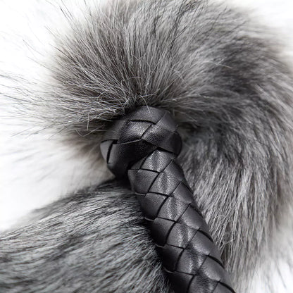 fox tail flogger moving in slow arc emphasizing playful dominance and petplay aesthetics