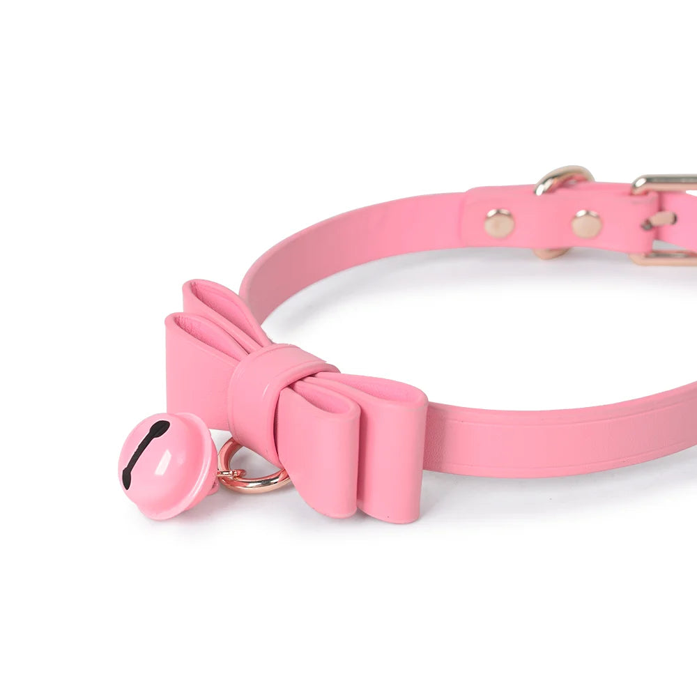 Close detail of pink leather collar with gold-tone bell