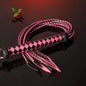 pink and black two-tone nine-tail flogger with leaf tips