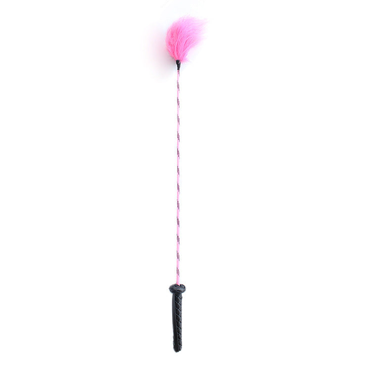 Front view of pink feather riding crop with pink-black shaft
