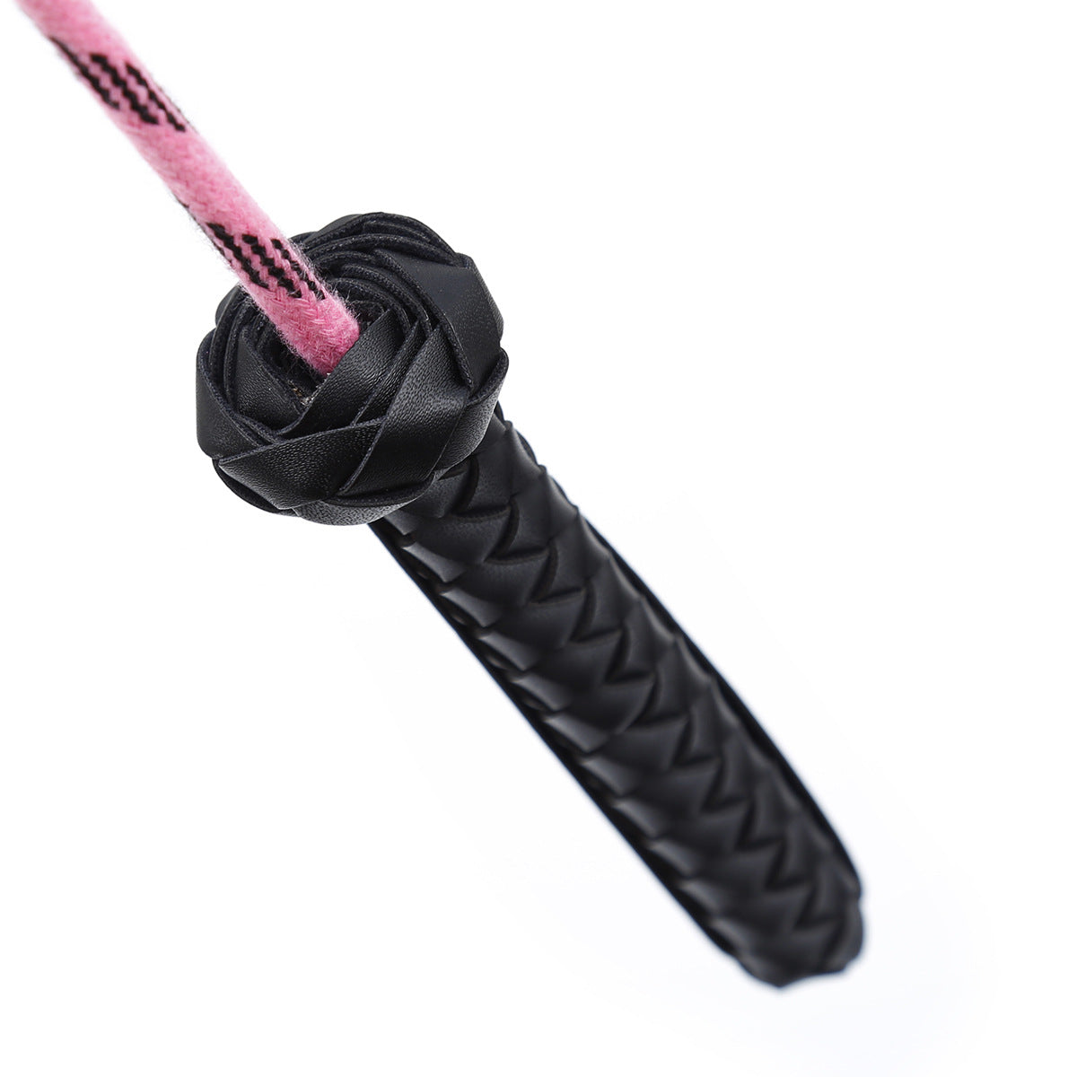 Close-up of faux leather handle on pink feather riding crop