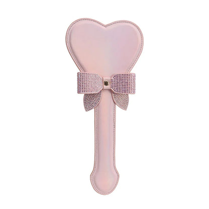 Pink iridescent heart-shaped spanking paddle front full view showing shimmer surface