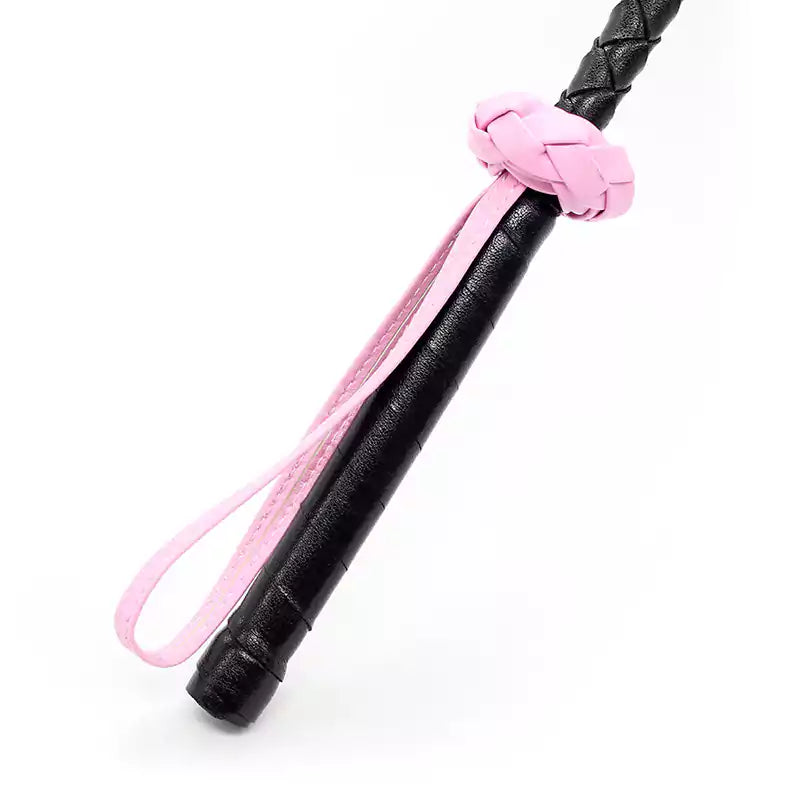Close-up of handle and wrist strap on pink star riding crop