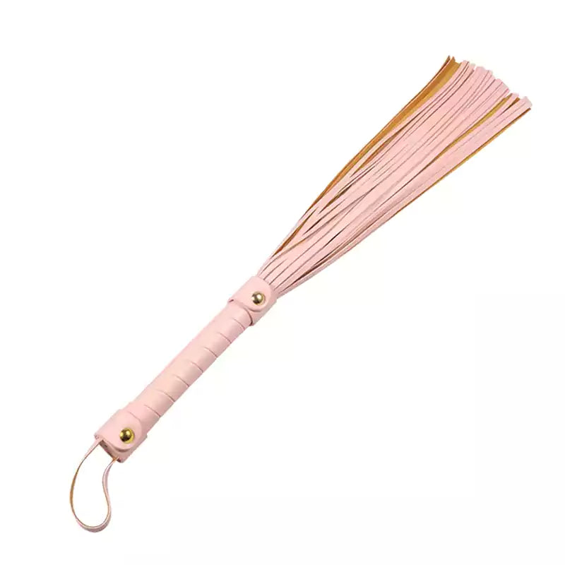 Pink tassel flogger full view under neutral studio lighting