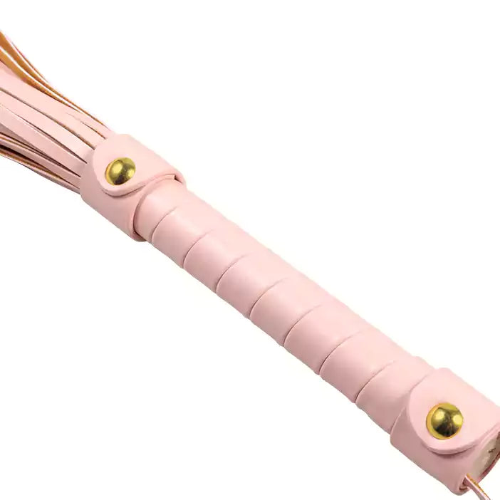 Close-up of pink faux leather flogger handle showing grip texture
