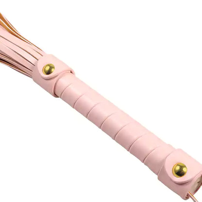 Close-up of pink faux leather flogger handle showing grip texture