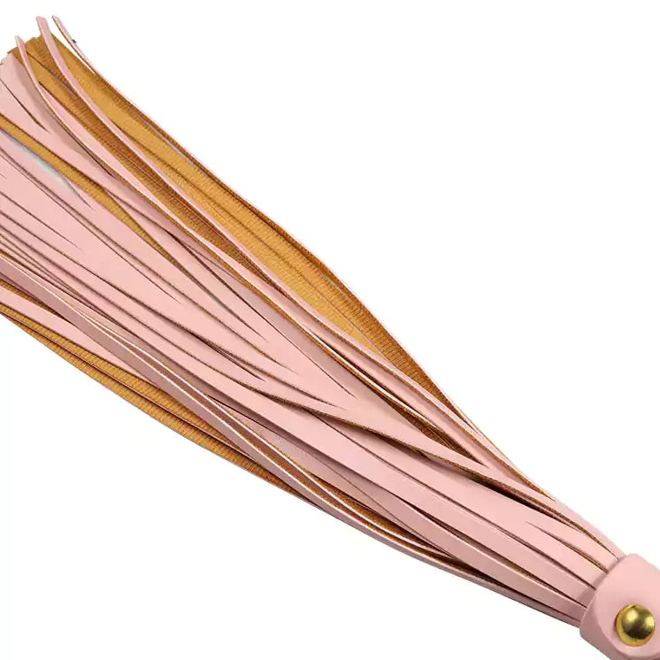 Detailed view of long pink tassel strands showing texture and alignment